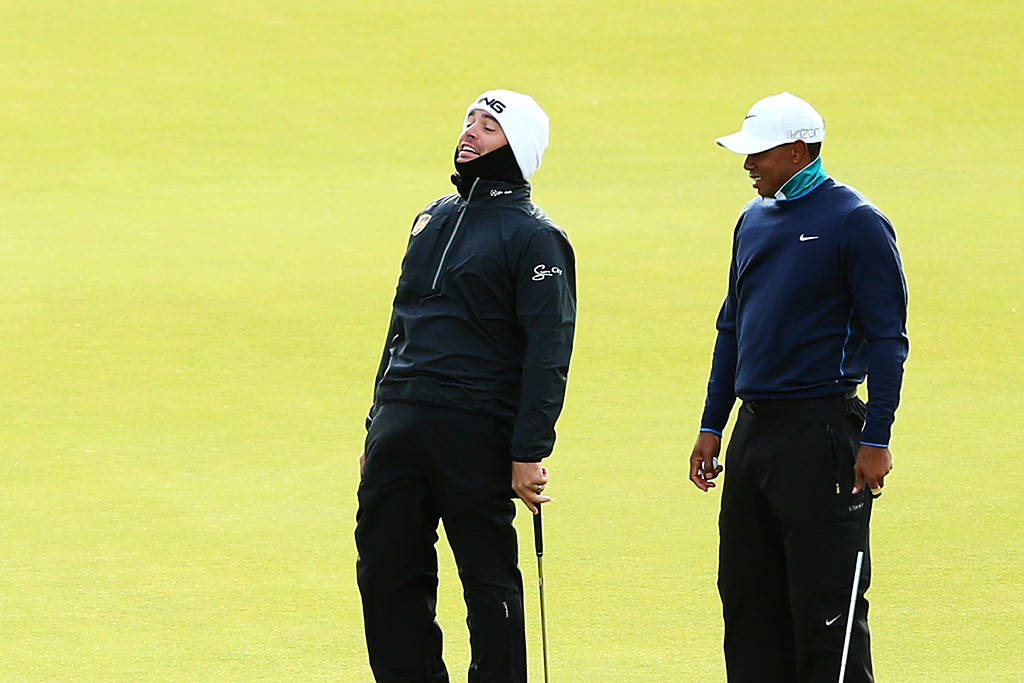 Louis Oosthuizen and Tiger Woods face the fierce winds at St Andrews in 2015